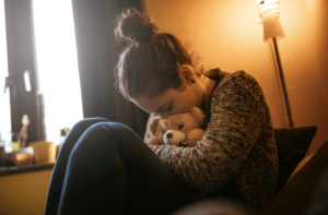 teen cuddling her animal to comfort herself as she struggles with depression after having teen therapy in Simi Valley, ca