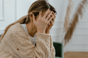 woman feeling frustrated and overwhelmed but able to calm herself down through coping mechanisms she learned from anxiety therapy