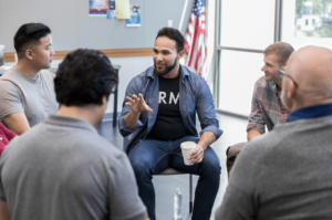 man with infertility talking with other men struggling with infertility and feels grateful that he wouldn't have found them if it weren't for therapy in simi valley