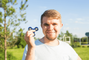 a man feeling calm after playing with his fidget toy thanks to neurodivergent therapy simi valley