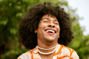 nonbinary person laughing after writing some queer writing prompts